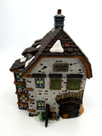 Sir John Falstaff Inn side view — stone gable end with water pump, stable doors and timber framing