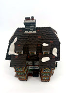 Sir John Falstaff Inn roof detail — snow-dusted slate shingles, chimneys and the hanging sign seen from above