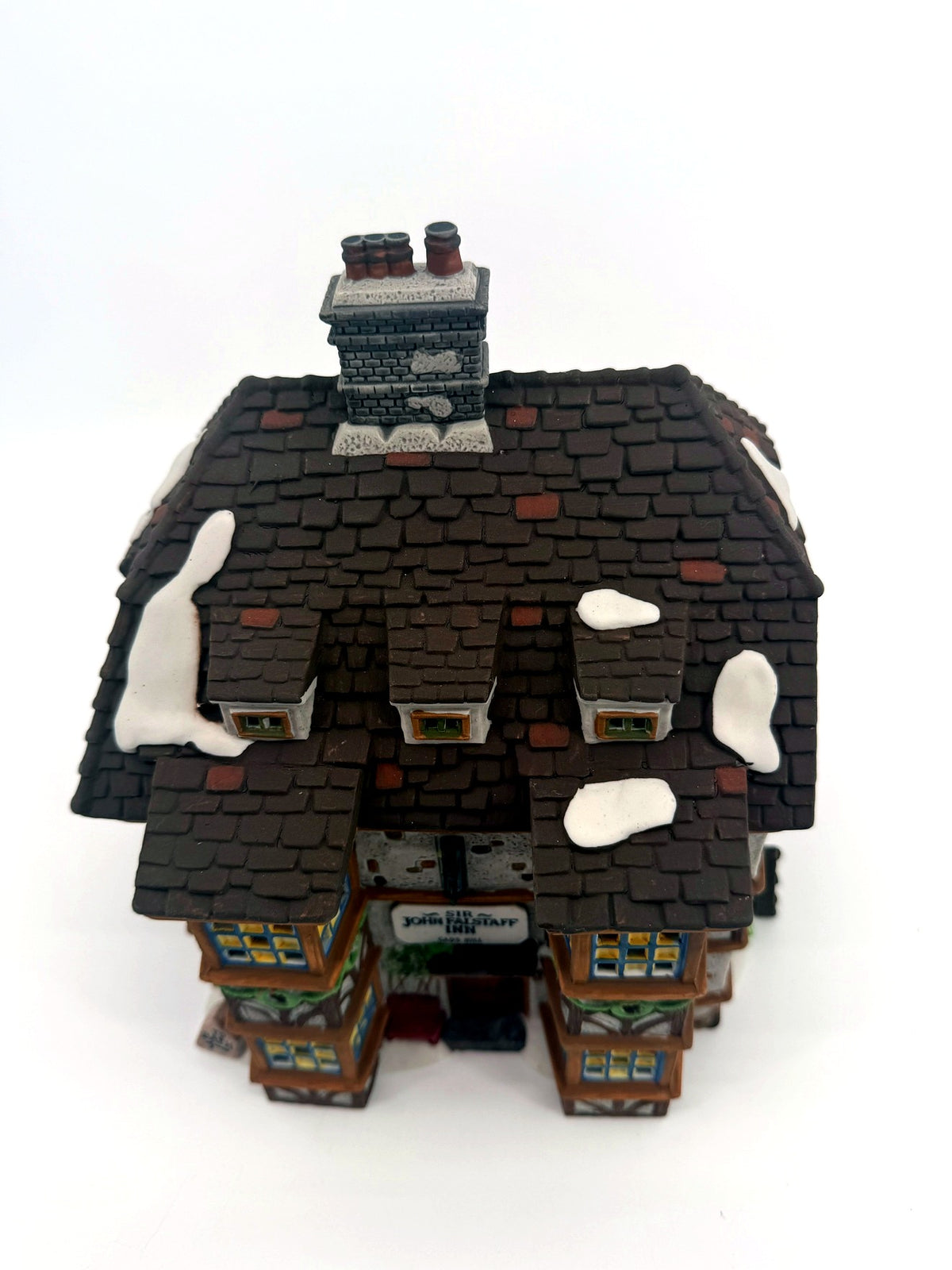 Sir John Falstaff Inn roof detail — snow-dusted slate shingles, chimneys and the hanging sign seen from above