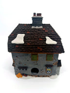 Sir John Falstaff Inn rear view — stone base with light cord opening and shuttered window