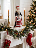 Styled lifestyle photo — on a white Christmas mantel with a lit garland, stockings, brass candlesticks and a decorated tree (display inspiration)