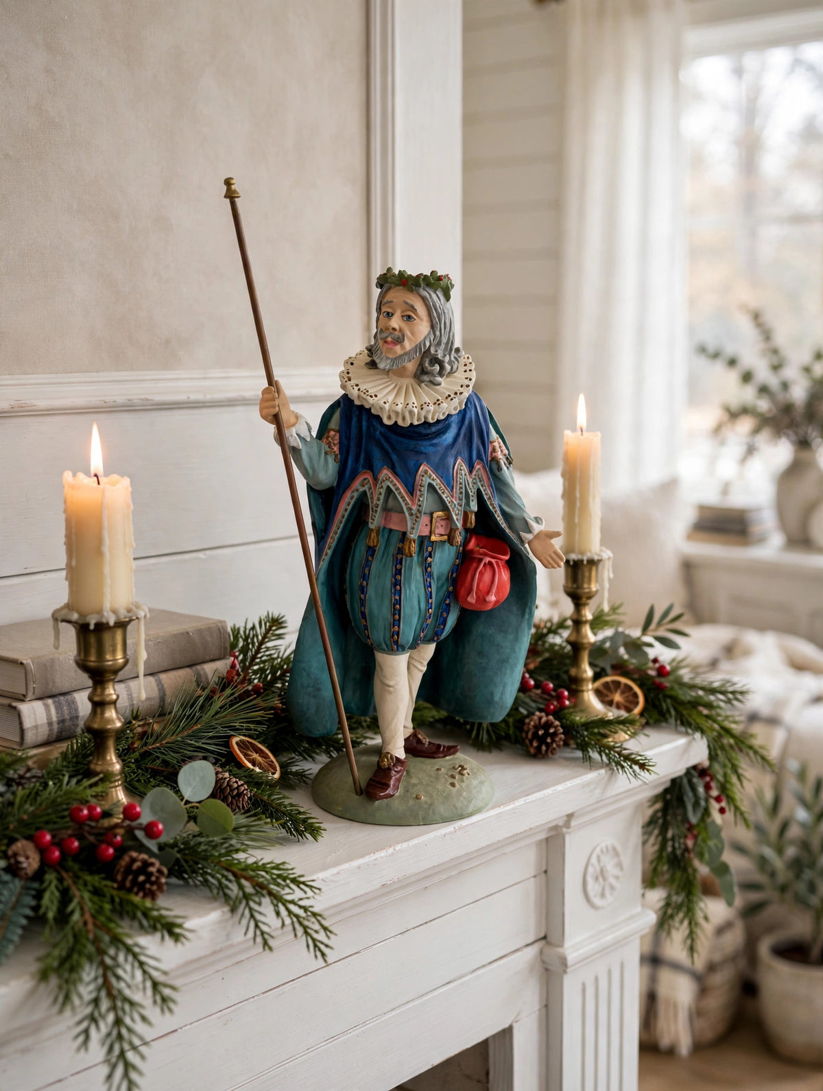 Styled lifestyle photo — display inspiration: Sir Christmas figurine on a fireplace mantel with lit candles, evergreen garland and holly