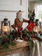 Styled lifestyle photo — display inspiration: Pioneer Santa figurine on a rustic farmhouse mantel with garland and lanterns