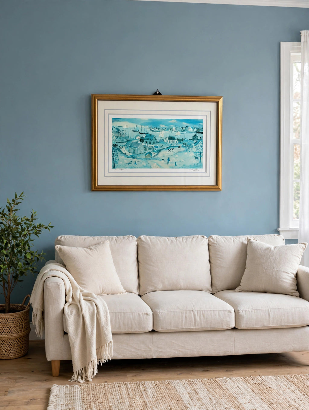 Styled lifestyle photo — the framed Shepherd's Nob lithograph hanging above a linen sofa in a bright living room with dusty blue walls (display inspiration)