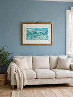 Styled lifestyle photo — the framed Shepherd's Nob lithograph hanging above a linen sofa in a bright living room with dusty blue walls (display inspiration)