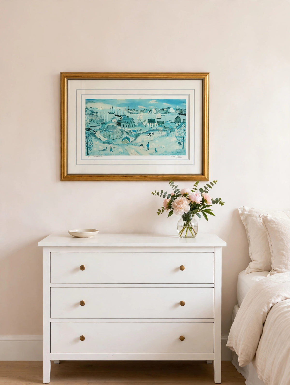 Styled lifestyle photo — the framed Shepherd's Nob lithograph hanging above a white dresser in a bright bedroom with blush and cream walls (display inspiration)