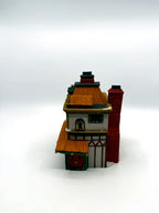 Side view with the tall red brick chimney and half-timbered wall