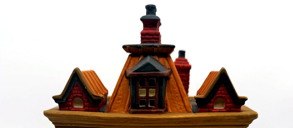 Detail of the mansard roof dormers and red brick chimneys