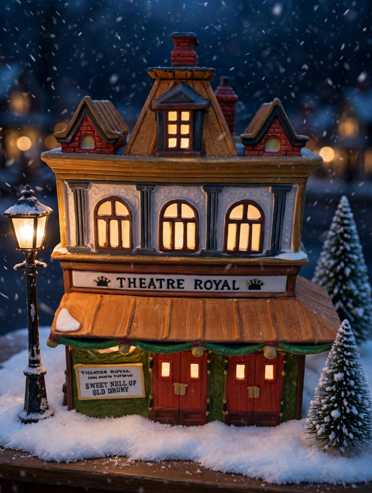 Styled lifestyle photo — Theatre Royal on a snowy Dickens village street at dusk with a glowing lamppost (display inspiration)