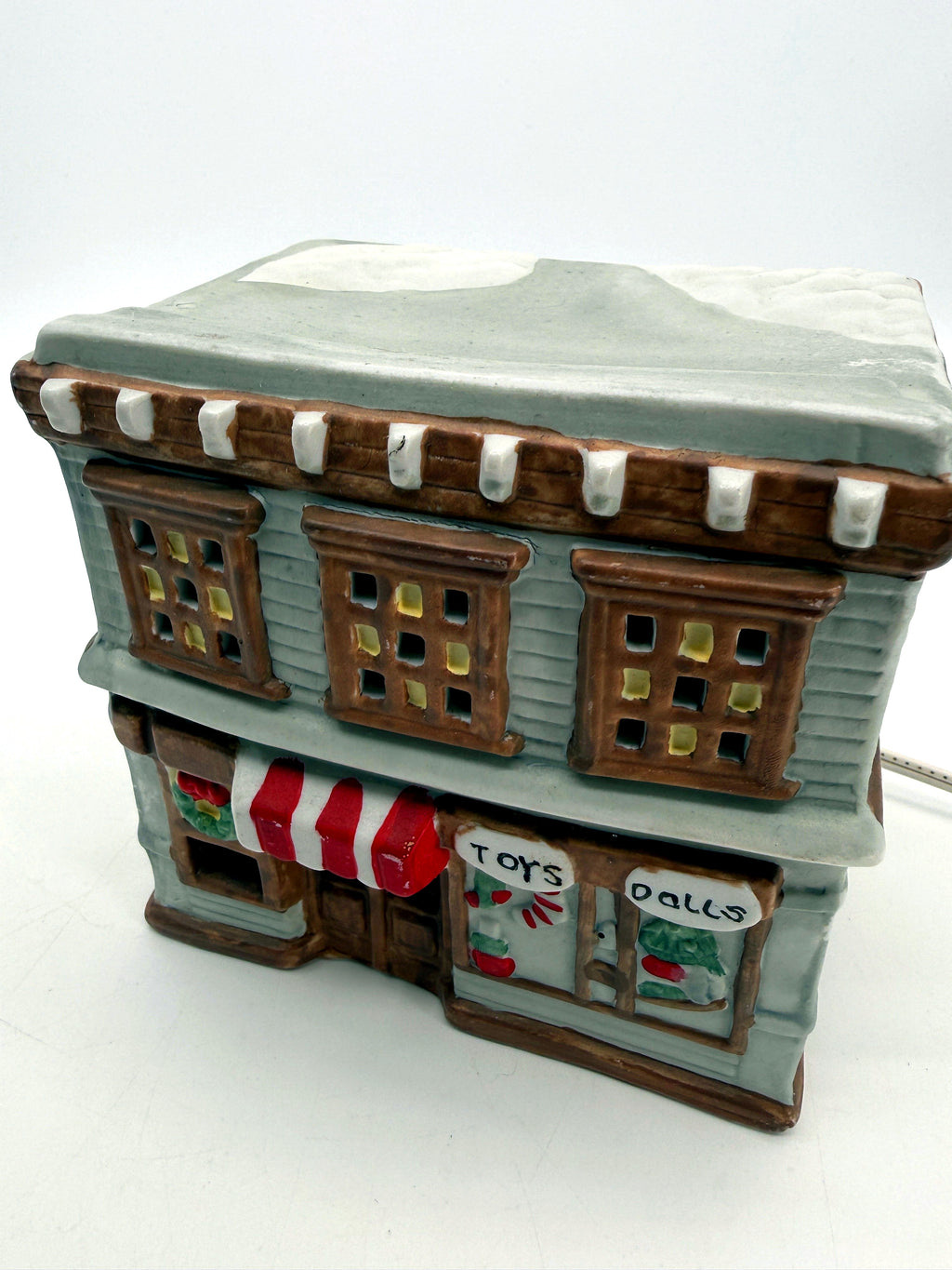 Ceramic Christmas village Toy and Doll shop, three-quarter front view