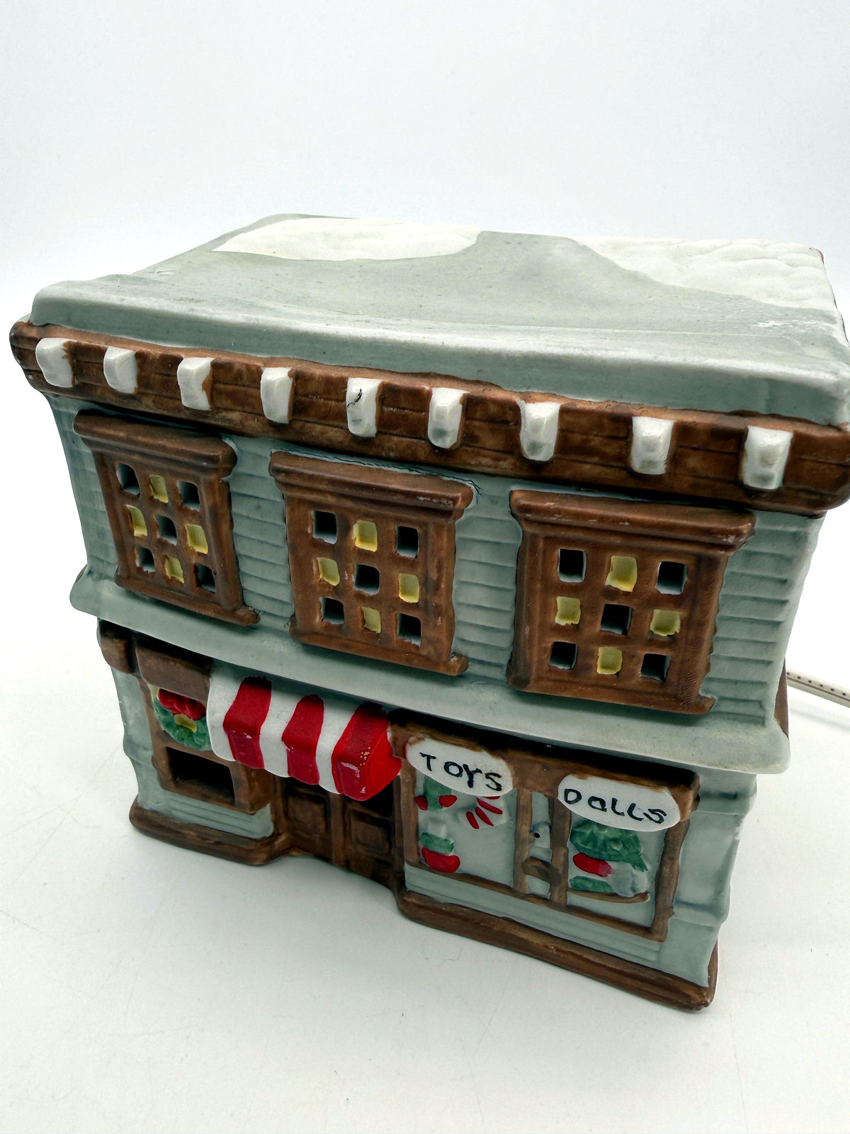 Ceramic Christmas village Toy and Doll shop, three-quarter front view