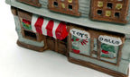 Close-up of the hand-painted Toys and Dalls shop signs and striped awning