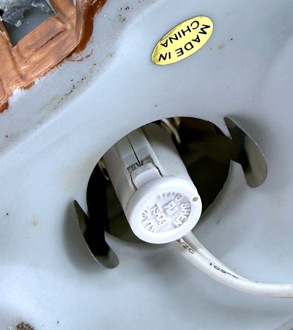 Close-up of the underside light socket and Made in China sticker