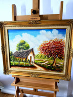 1984 signed oil on canvas tropical cottage landscape, framed — front view on an easel