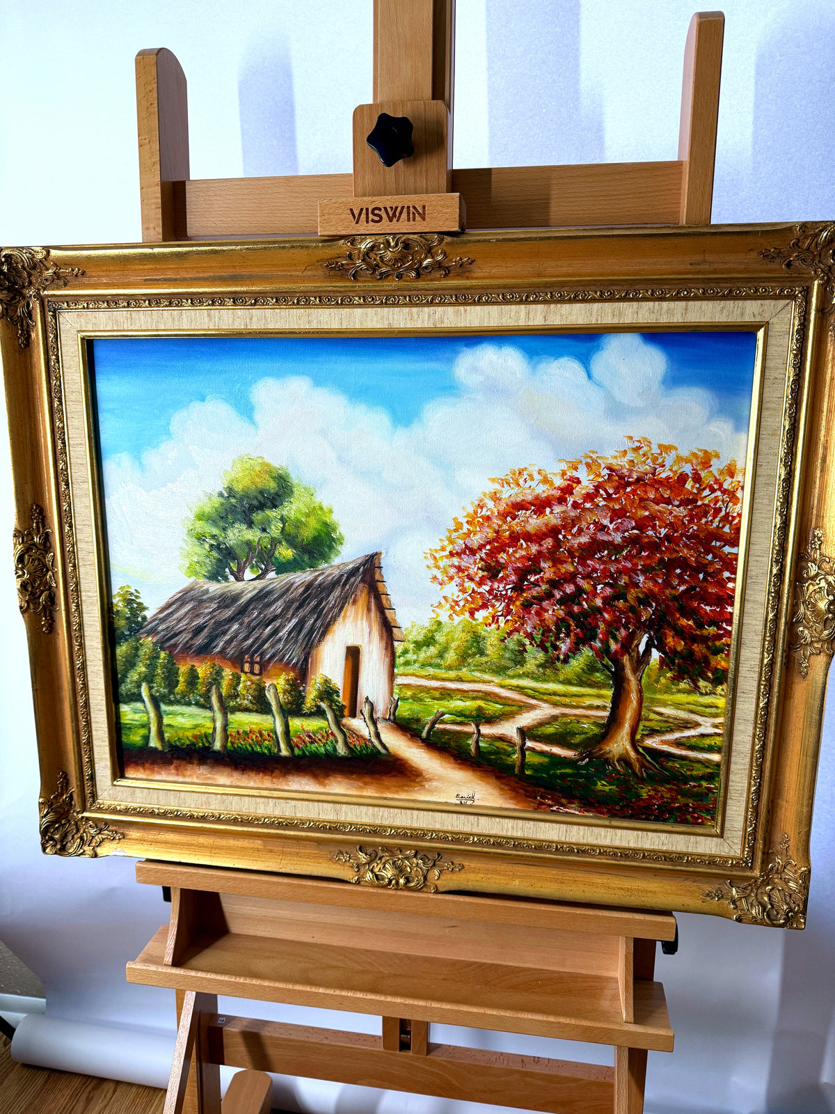1984 signed oil on canvas tropical cottage landscape, framed — front view on an easel