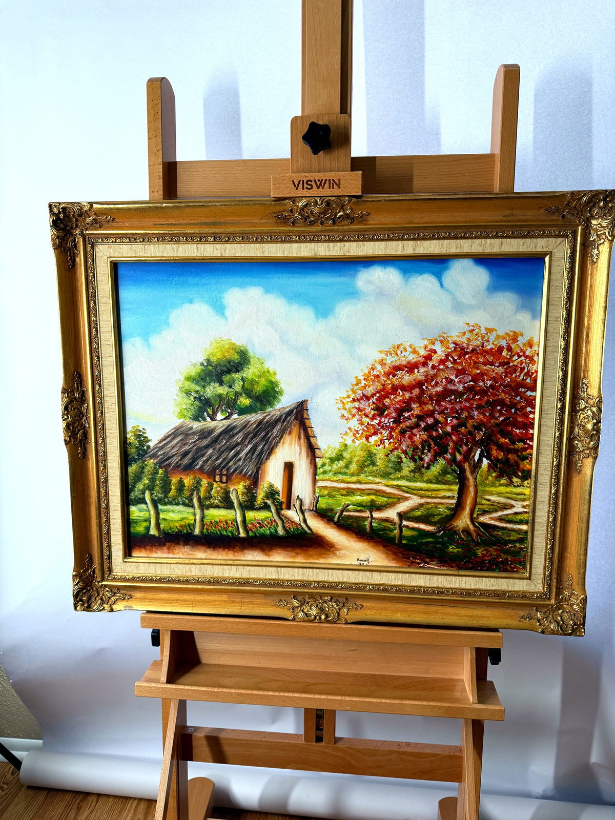 1984 signed oil on canvas tropical cottage landscape, framed — front view on an easel