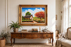 Styled lifestyle photo — the framed 1984 tropical cottage landscape above an antique wooden sideboard in a vintage living room (display inspiration)