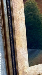 Detail close-up — the bronze-gold frame corner, dark inner molding and textured mat
