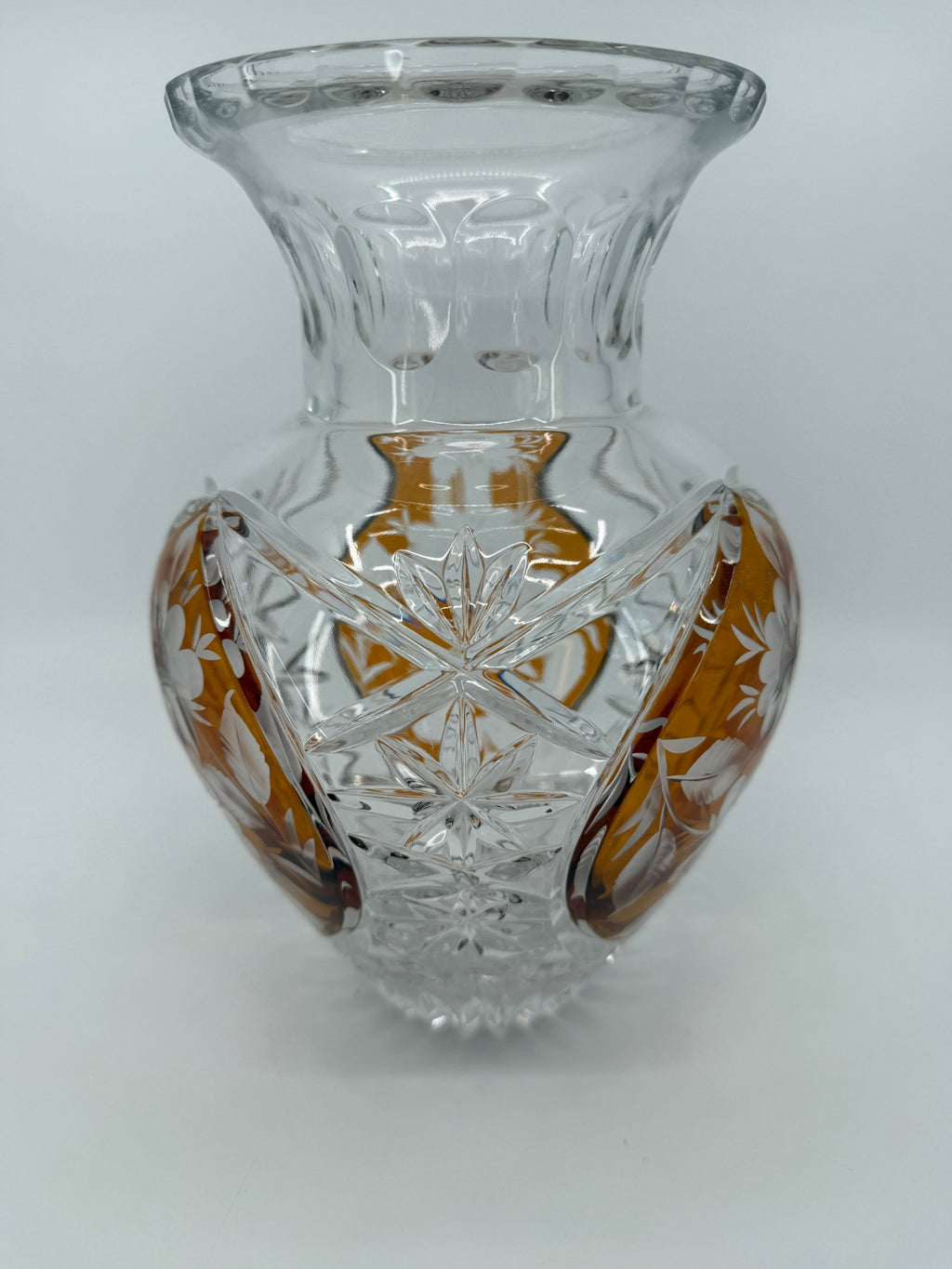 Amber crystal vase, three-quarter close view showing starburst cutting (original color)