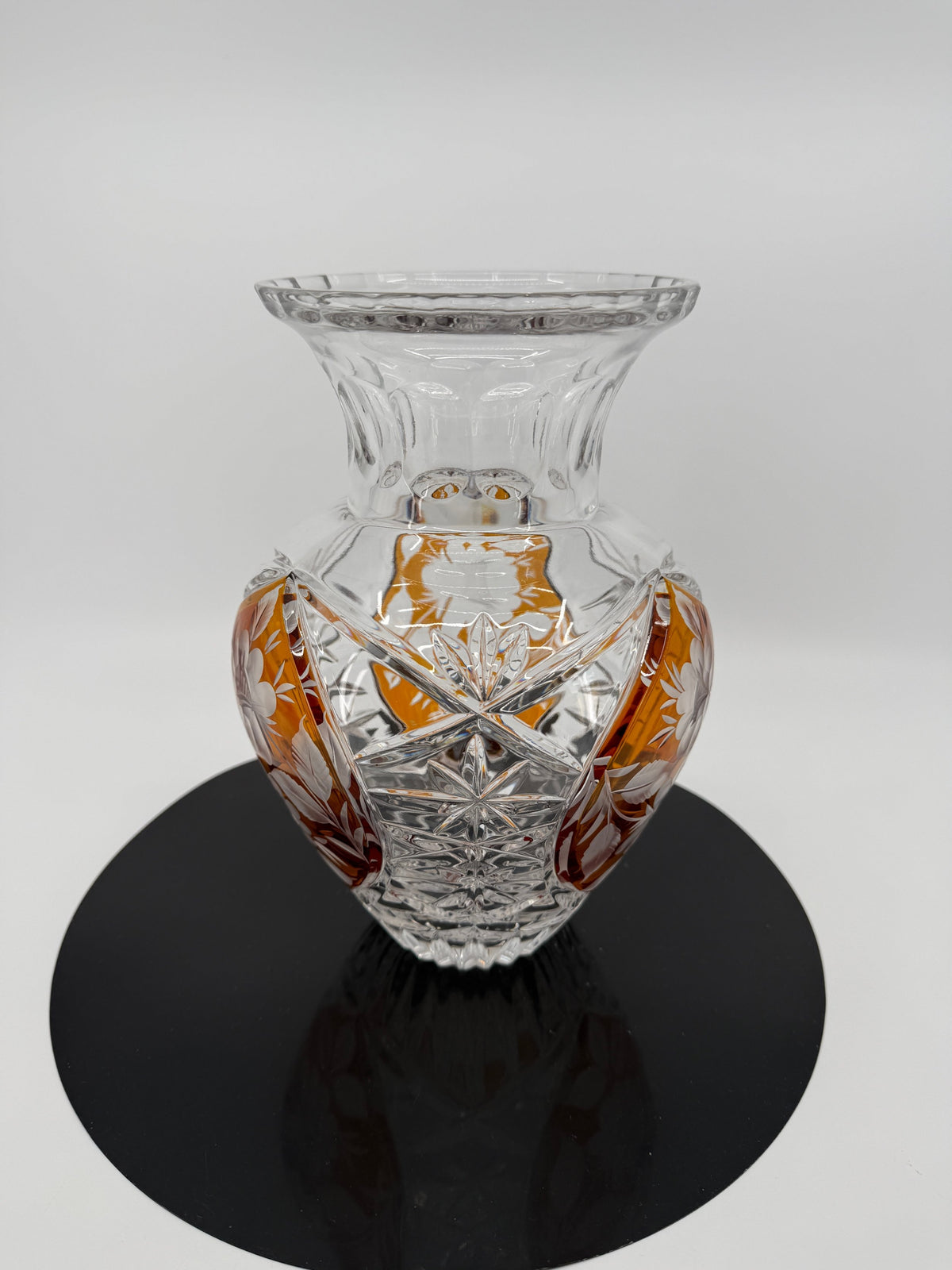 Amber crystal vase, close view on display stand showing starburst cutting (original color)