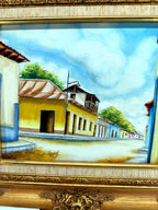 1984 signed oil on canvas Venezuelan street scene, framed — close-up of the painting — the yellow building with its tiled roof and balcony