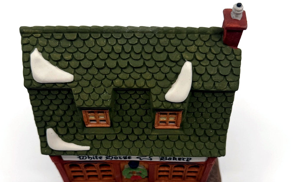 Detail: green fish-scale shingle roof with snow patches (detail from seller photo)