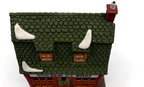 Detail: green fish-scale shingle roof with snow patches (detail from seller photo)