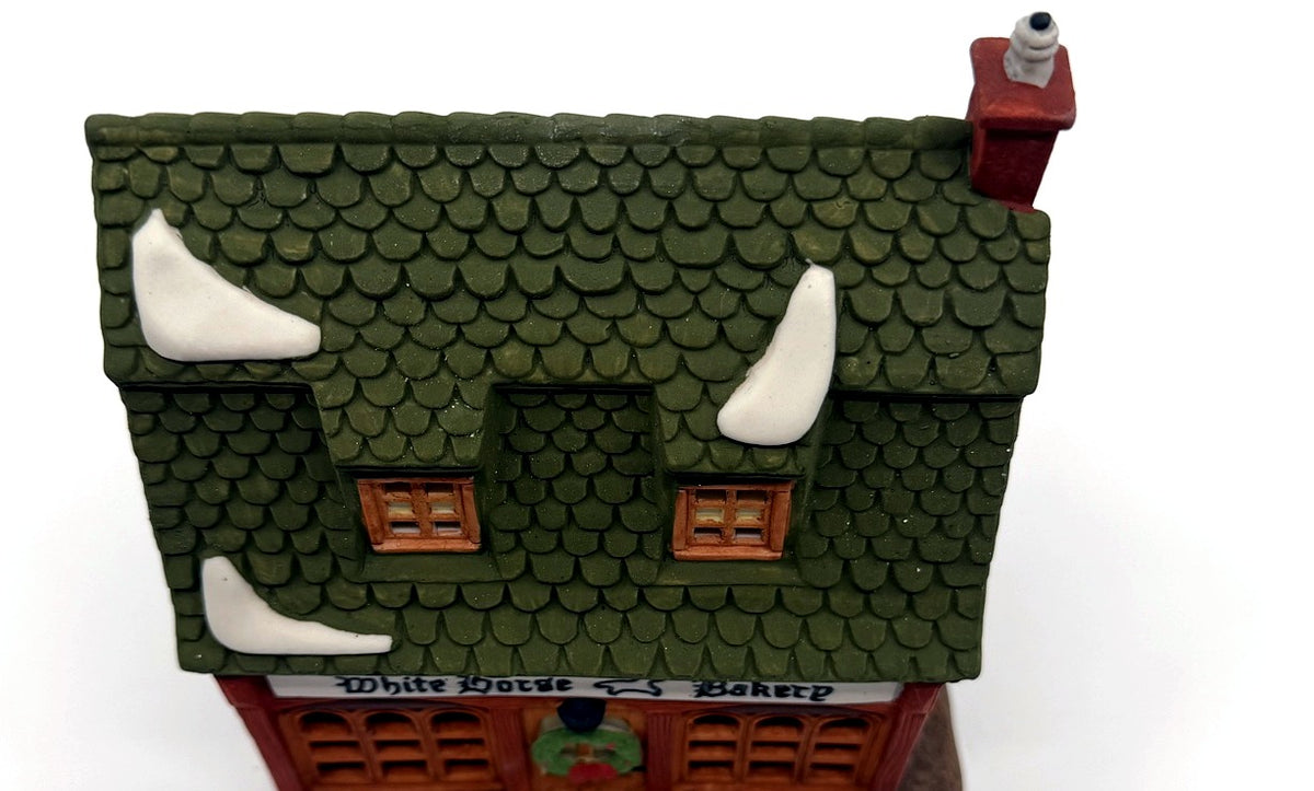 Detail: green fish-scale shingle roof with snow patches (detail from seller photo)