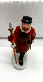 Close-up of a Beefeater guard figurine - Tudor rose tunic, white ruff collar and halberd